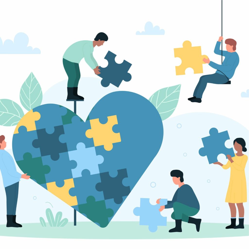 Varias personas colocan piezas de puzle para completar un gran corazón azul.